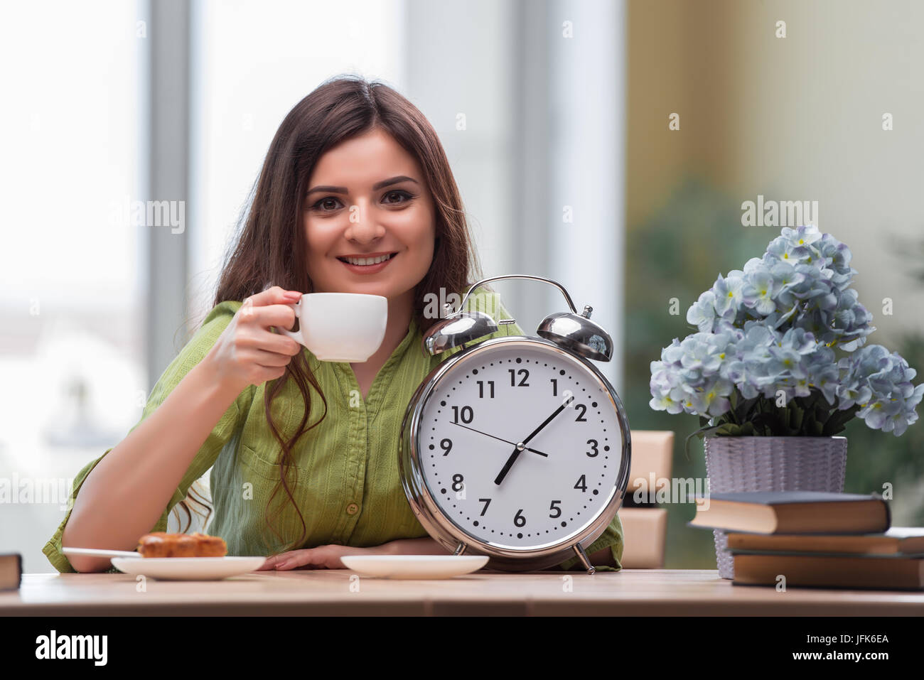 Student with gian alarm clock preparing for exams Stock Photo Alamy