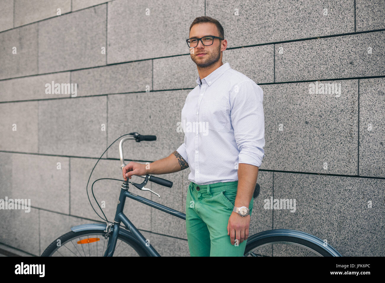 Confident business man with bike. Confident young handsome man in shirt Stock Photo