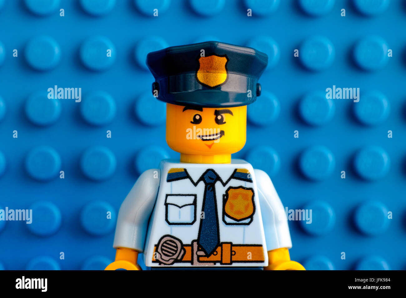 Tambov, Russian Federation - June 03, 2017 Portrait of Lego policeman minifigure with blue baseplate background. Studio shot. Stock Photo
