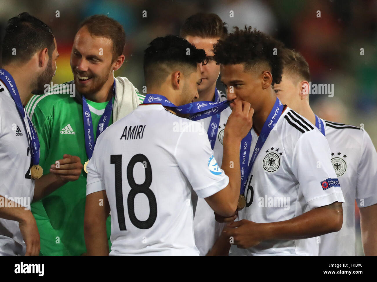 Cracow, Poland. 30th June, 2017. Germany's Nadiem Amiri (C) and Thilo Kehrer (R) happy about their victor's medals after the U21 European Championship final match between Spain and Germany at the Cracovia stadium in Cracow, Poland, 30 June 2017. Photo: Jan Woitas/dpa-Zentralbild/dpa/Alamy Live News Stock Photo