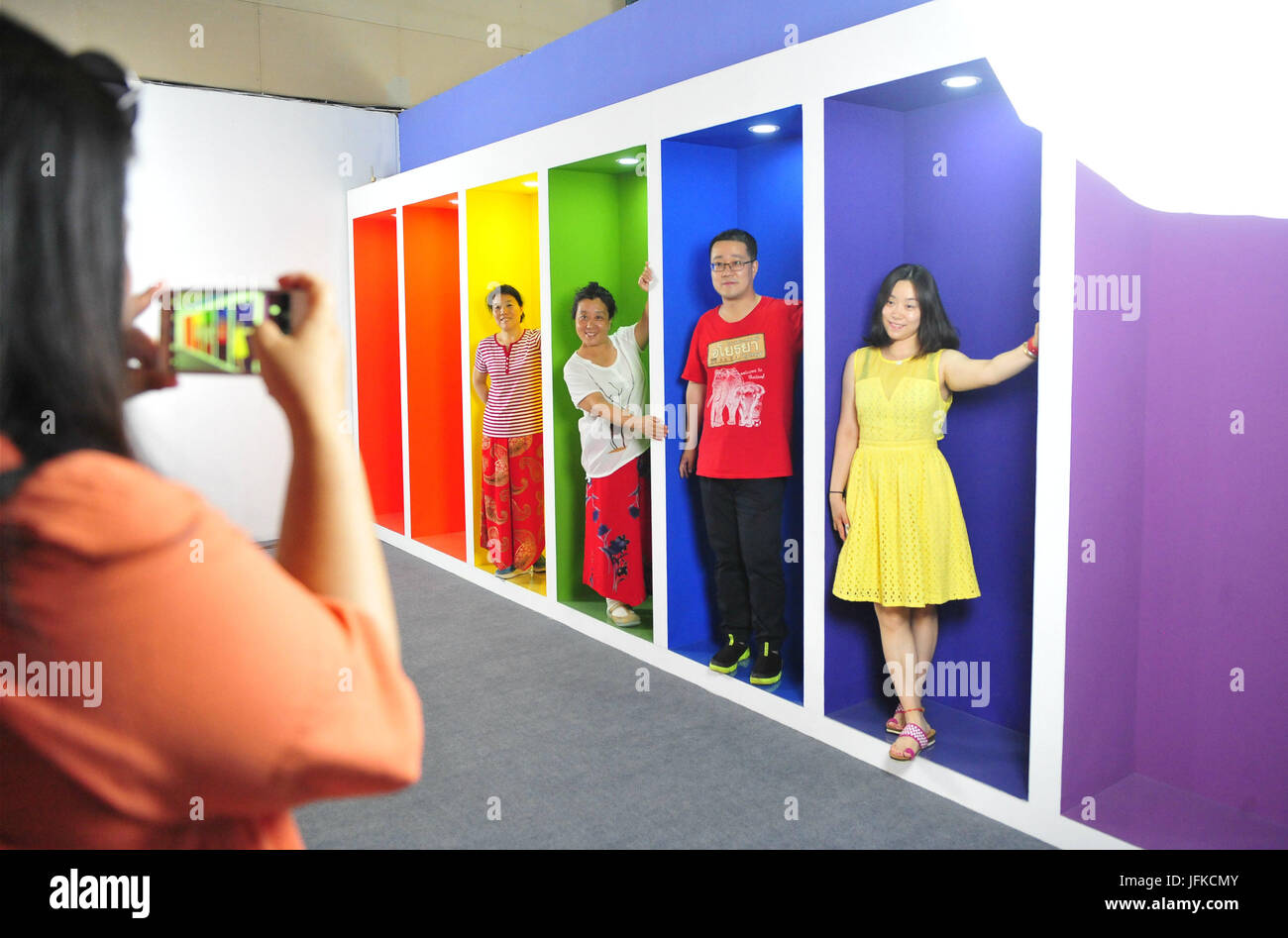 Beijing, China. 1st July, 2017. Visitors pose for photos during a photo studio exhibition in Beijing, capital of China, July 1, 2017. More than 100 shooting scenes and more than 200 lights are set during the exhibition, with which people can create their own photos. The exhibition will last until October. Credit: Xiao Xiao/Xinhua/Alamy Live News Stock Photo
