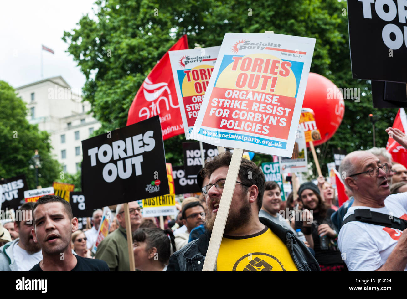 London, UK. 01st July, 2017. Demonstrators carry placards during the 'Not One Day More' march past Piccadilly Circus on July 1, 2017 in London, England. Thousands of protesters joined the anti-Tory demonstration at BBC Broadcasting House and marched to Parliament Square. The demonstrators were calling for an end to the Conservative Government and policies of austerity Credit: onebluelight.com/Alamy Live News Credit: onebluelight.com/Alamy Live News Stock Photo