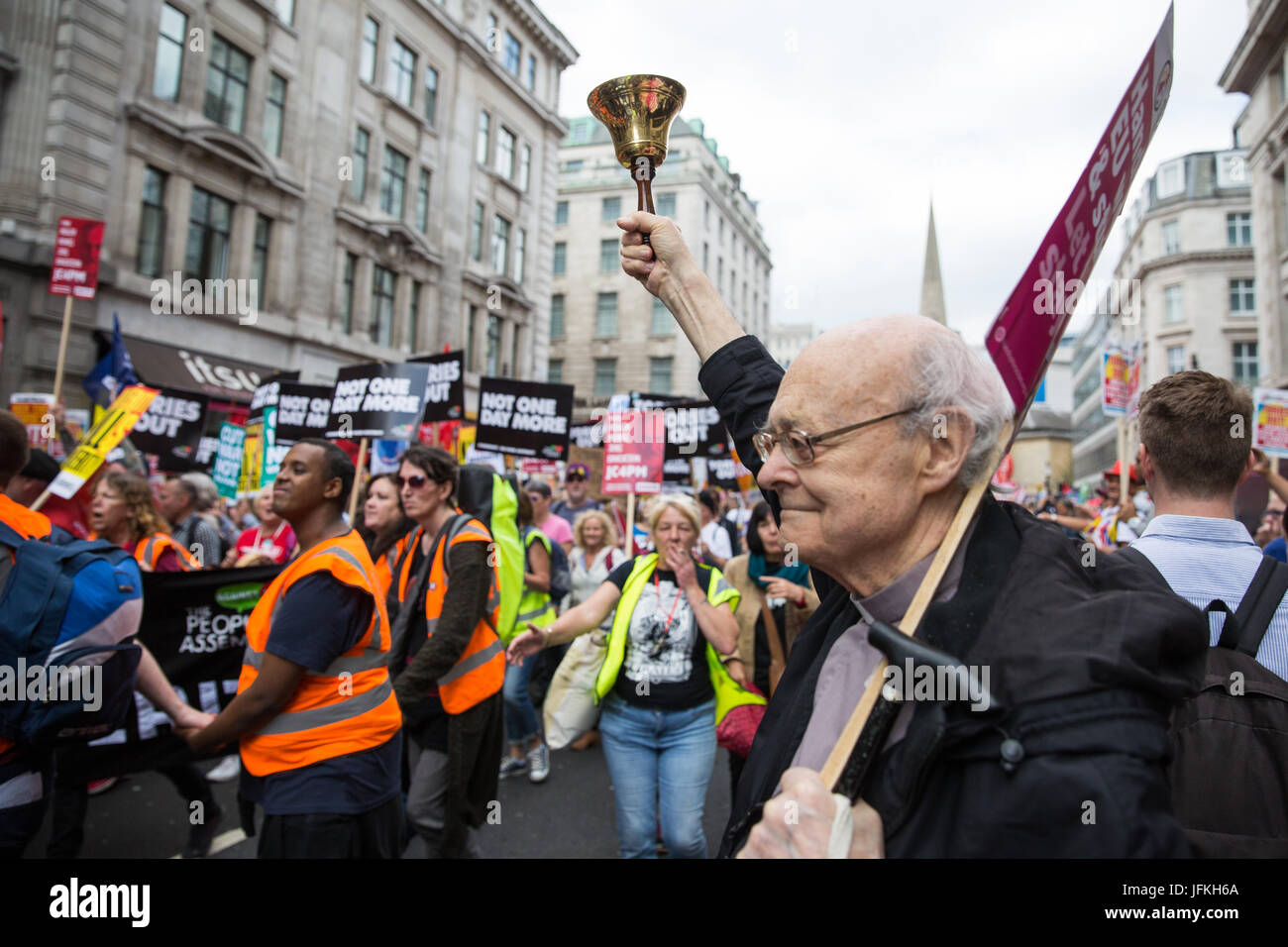 London, UK. 1st July, 2017. The Rev. Paul Nicolson rings a bell as thousands of people from many different campaign groups and trade unions pass on the Not One More Day national demonstration organised by the People's Assembly Against Austerity in protest against continuing austerity, cuts and privatisation and to call for a properly funded health service, education system and housing. A minute's silence was also held for the victims of the fire at Grenfell Tower. Stock Photo