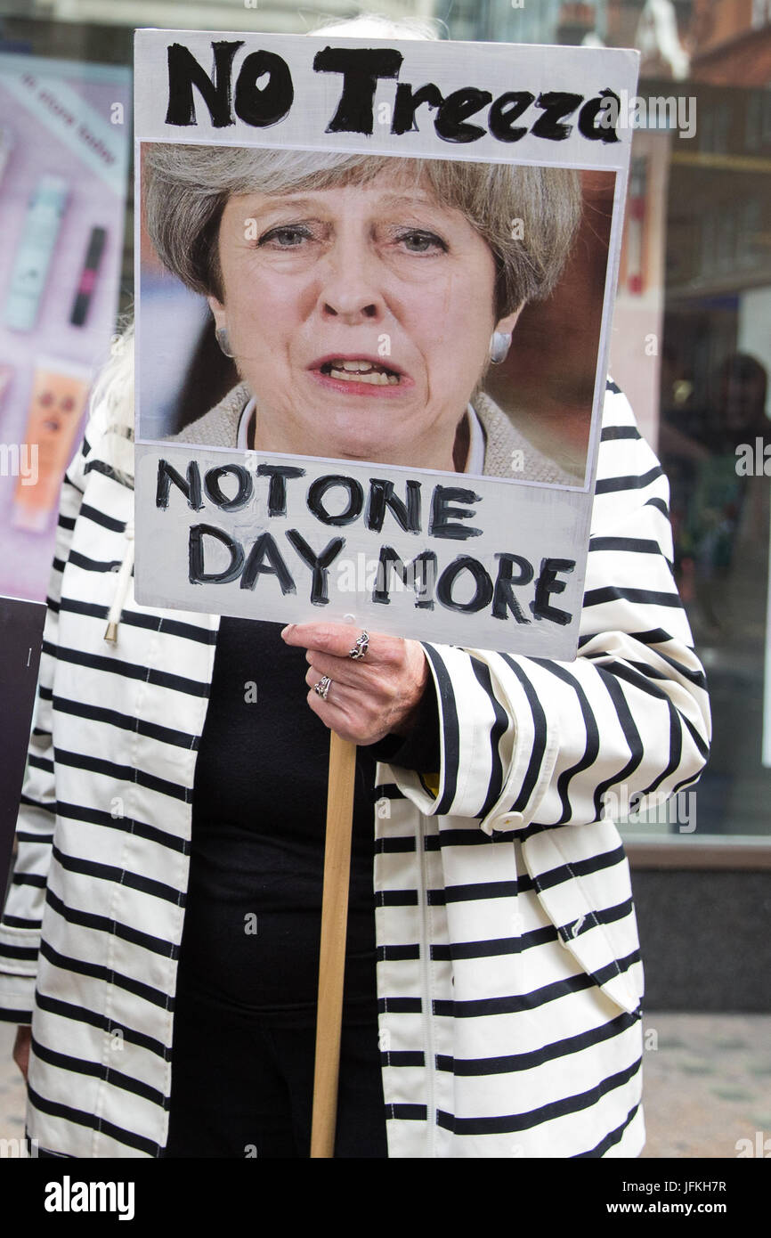 London, UK. 1st July, 2017. A protester holds a placard on the Not One More Day national demonstration organised by the People's Assembly Against Austerity in protest against continuing austerity, cuts and privatisation and to call for a properly funded health service, education system and housing. A minute's silence was also held for the victims of the fire at Grenfell Tower. Credit: Mark Kerrison/Alamy Live News Stock Photo
