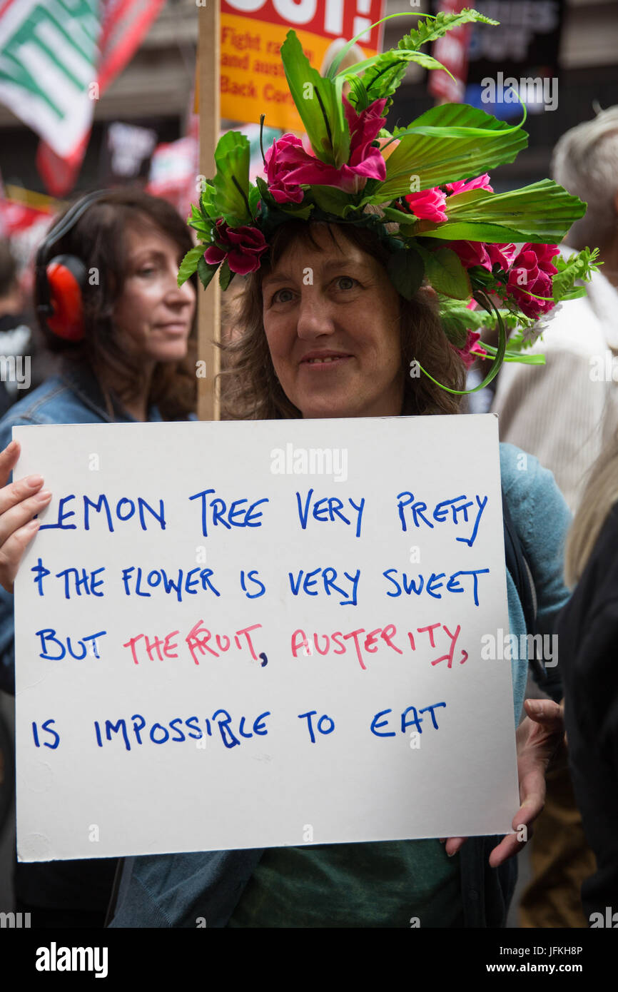 London, UK. 1st July, 2017. A woman holds a sign on the Not One More Day national demonstration organised by the People's Assembly Against Austerity in protest against continuing austerity, cuts and privatisation and to call for a properly funded health service, education system and housing. A minute's silence was also held for the victims of the fire at Grenfell Tower. Credit: Mark Kerrison/Alamy Live News Stock Photo