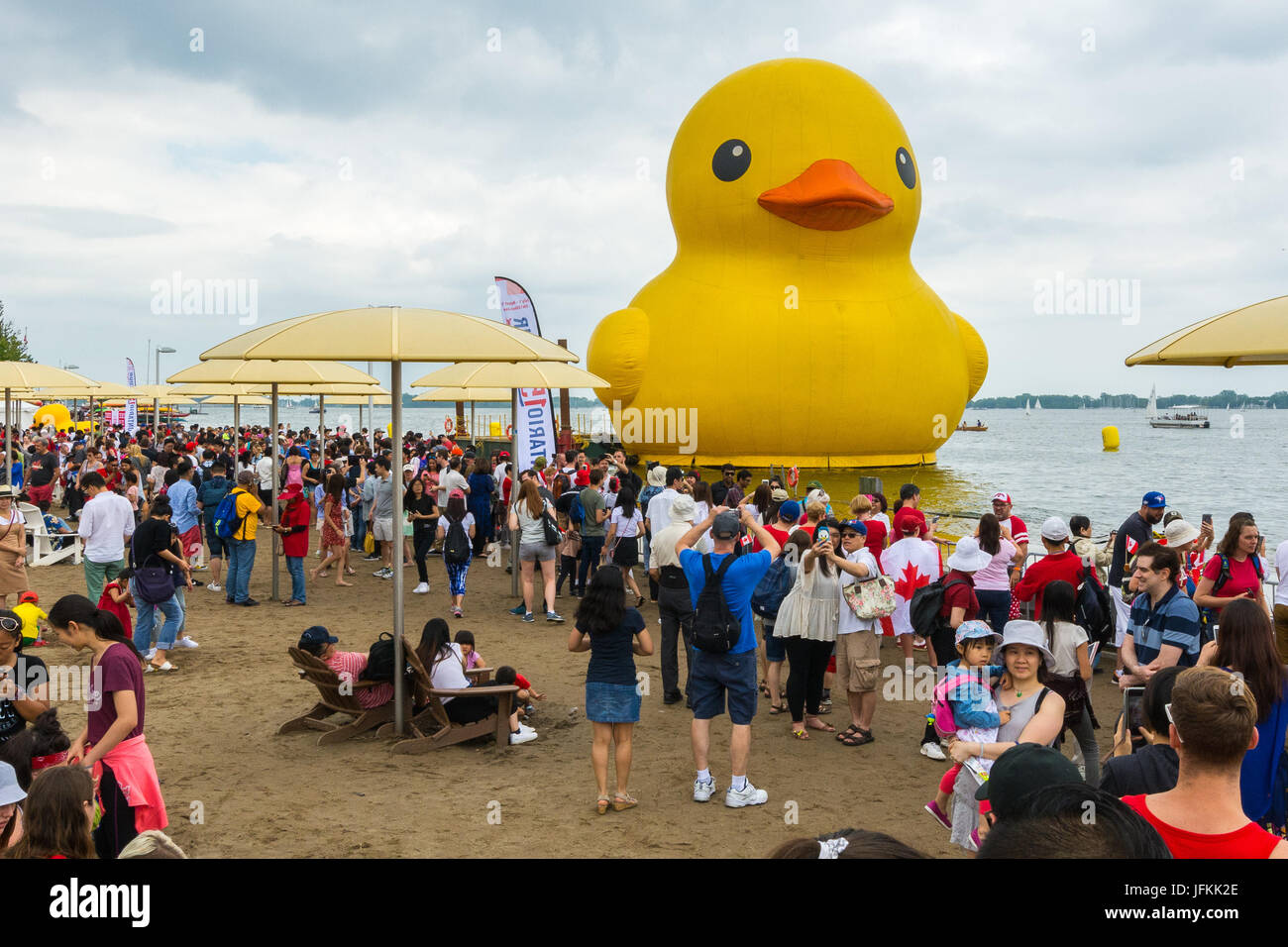 Toronto, Canada. 1st July 2017. People crowd the HTO Park to take pictures and selfies of the World's Largest Rubber Duck during the Redpath Waterfront Festival as part of Canada 150 celebration. Dominic Chan/EXimages Stock Photo