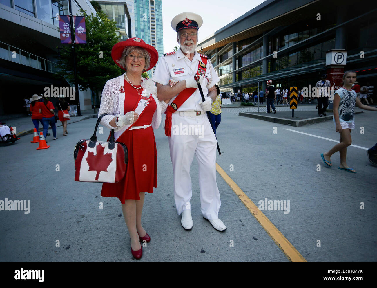 Vancouver, Canada. 1st July, 2017. A couple wear patriotic outfits during the Canada Day celebration at Canada Place in Vancouver, Canada, July 1, 2017. People gathered at Canada Place in downtown Vancouver to celebrate the 150th anniversary of Canada on Saturday. Credit: Liang sen/Xinhua/Alamy Live News Stock Photo