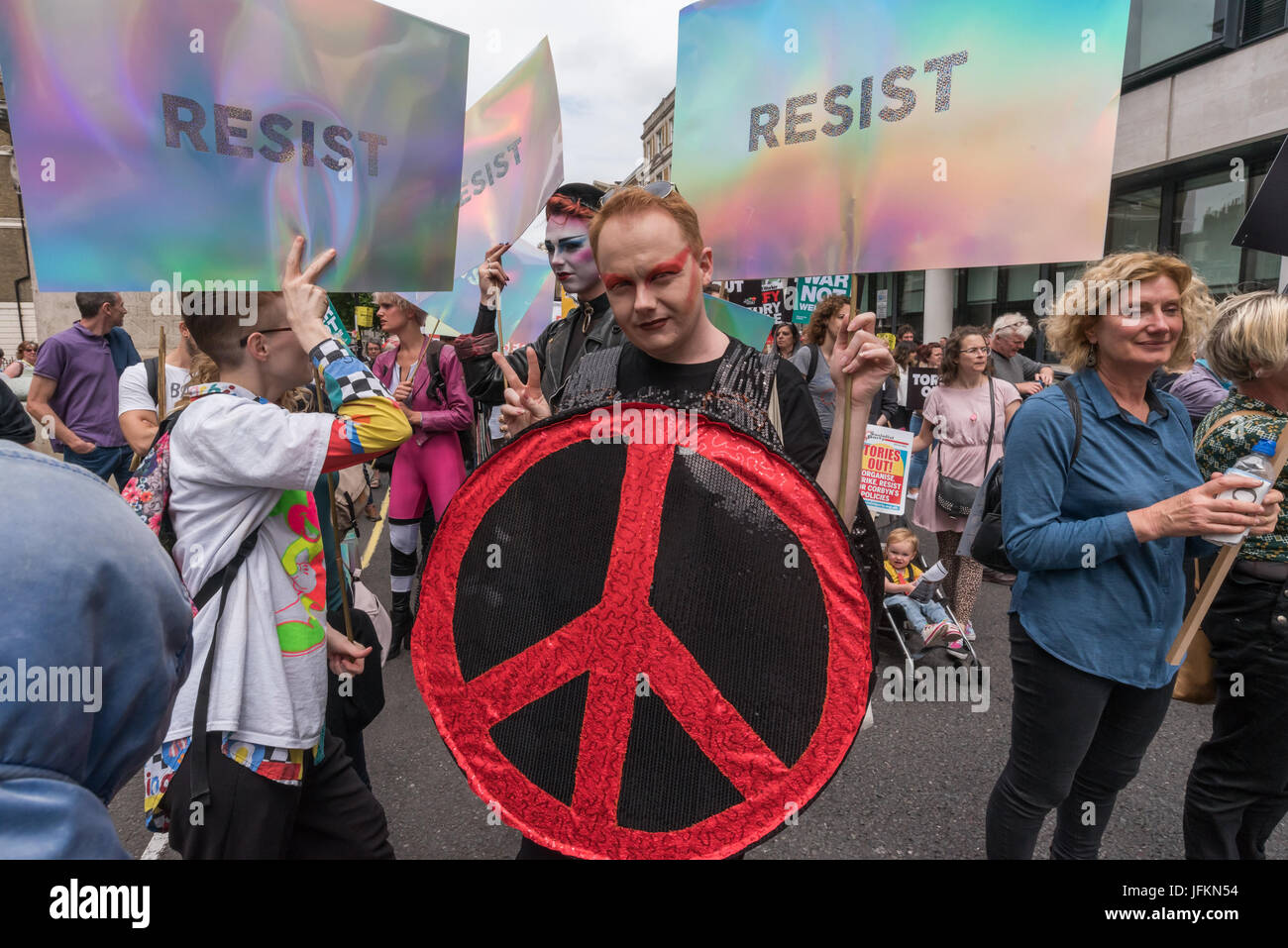 July 1, 2017 - London, UK - London, UK. 1st July 2017. 'Resist' is the message from these protesters at the start of the large march which met at the BBC and marched to Parliament Square calling for Theresa May and the Conservatives to go. Her snap election failed to deliver a majority and we now have a government propped up the DUP, a deeply bigoted party with links to Loyalist terrorists and bribed to support her. The election showed a rejection of her austerity austerity policies and the Grenfell Tower disaster underlined the toxic effects of Tory failure and privatisation of building regul Stock Photo