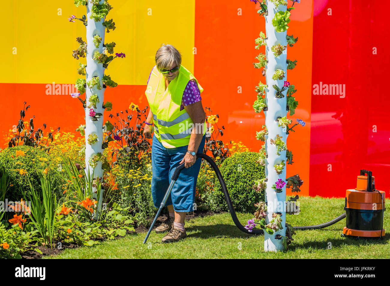 Hampton Court Palace, London, UK. 02nd July, 2017. Attention to detail, hoovering the grass, on the Journey of Life Garden by Edward Mairis -  Preparations for the Hampton Court Flower Show, organised by the  Royal Horticultural Society (RHS). In the grounds of the Hampton Court Palace, London, 02 July 2017 Credit: Guy Bell/Alamy Live News Stock Photo
