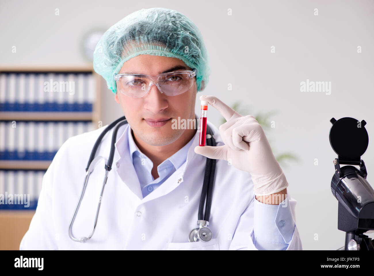 Young doctor working in the lab with microscope Stock Photo - Alamy