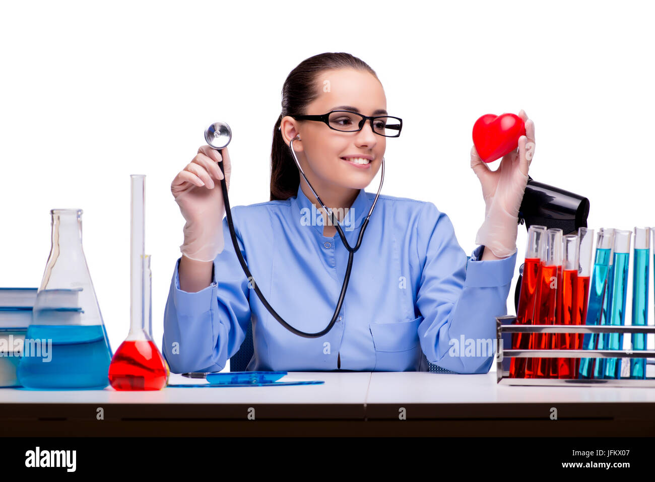 Young doctor with red heart isolated on white Stock Photo - Alamy