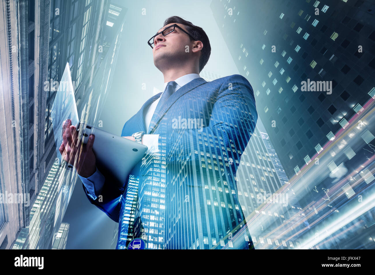 Businessman against buildings in business concept Stock Photo