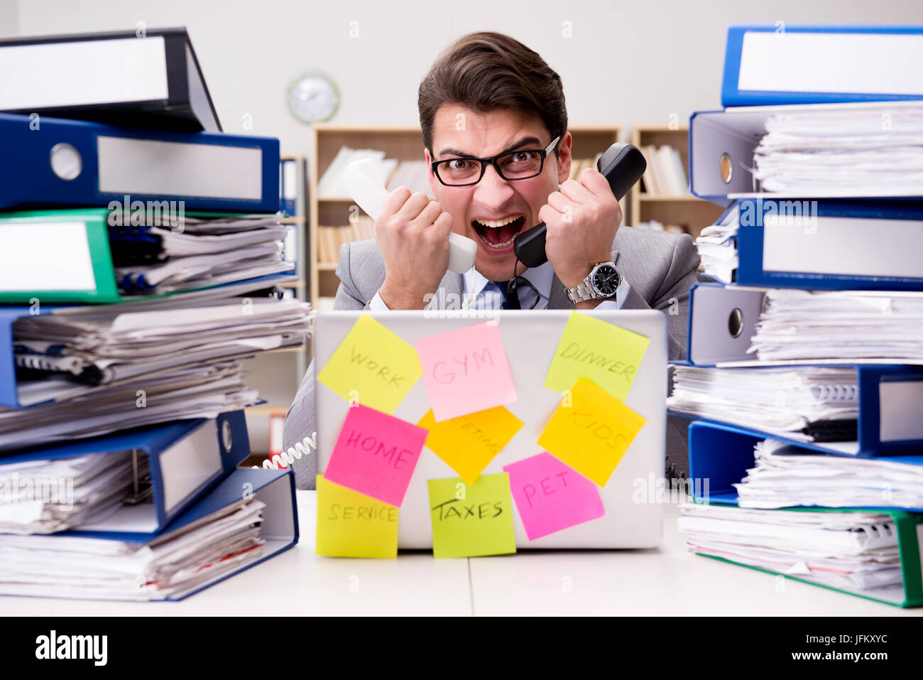 Multiple Priorities Image Businessman struggling with multiple priorities Stock Photo - Alamy