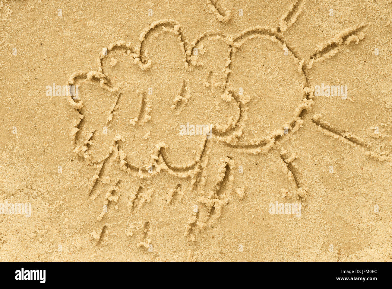 cloud and sun drawing in sand background Stock Photo