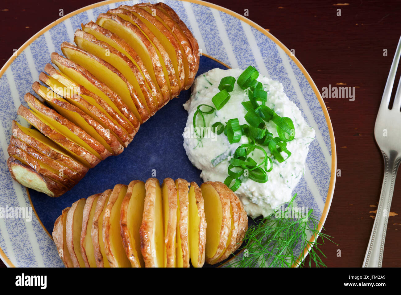 Baked potatoes on wooden table, closeup slide Stock Photo