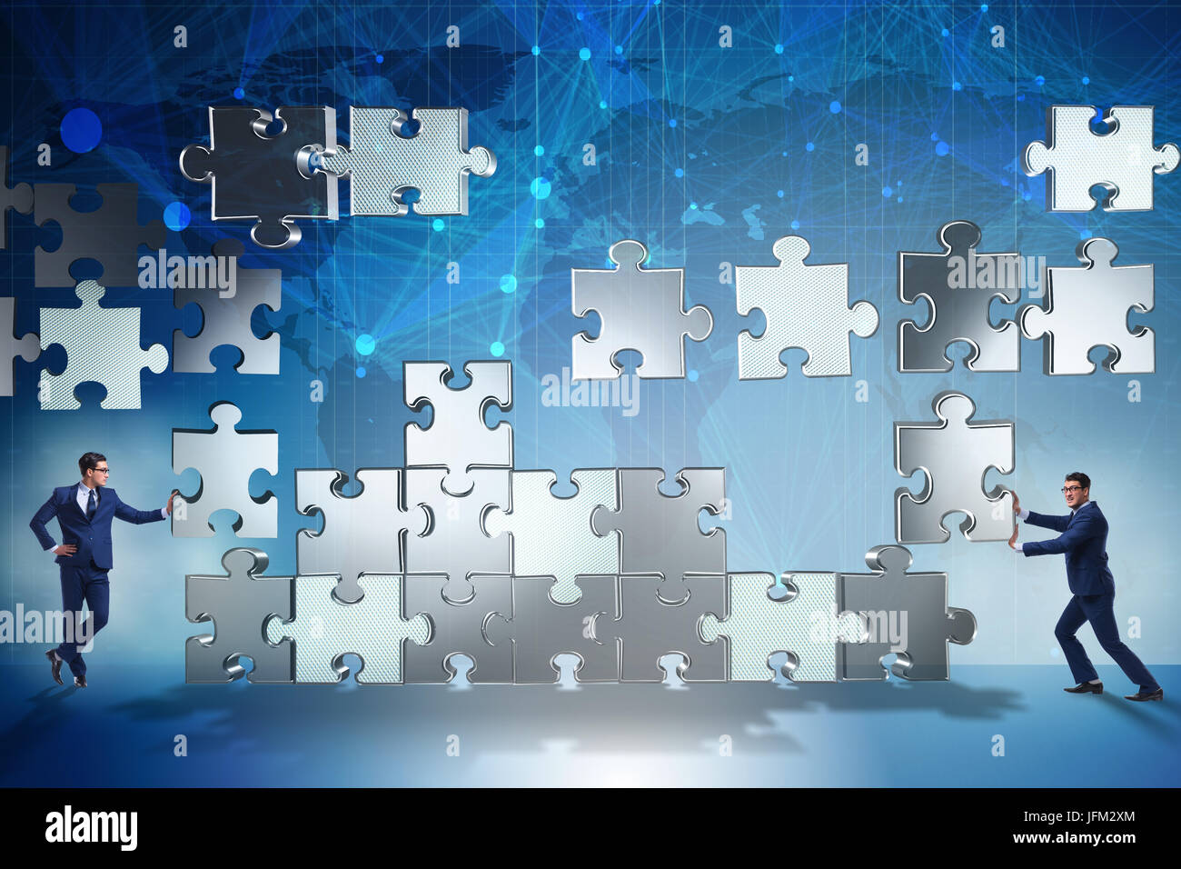 Business people pushing puzzle part hi-res stock photography and images -  Alamy