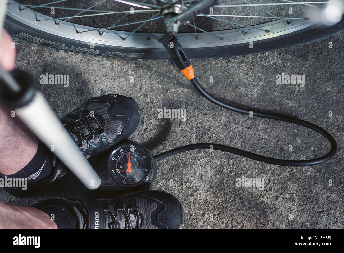 Pumping up the mountain bicycle tire using a track pump Stock Photo
