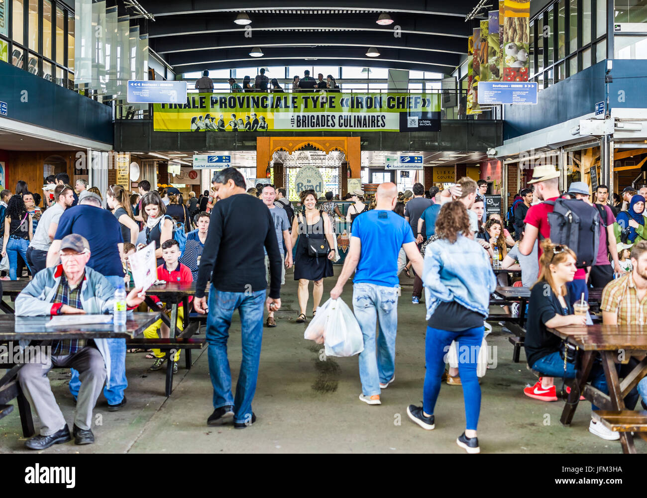 Montreal, Canada - May 28, 2017: Jean Talon market sign and entrance with people inside building eating sitting on tables in city in Quebec region Stock Photo
