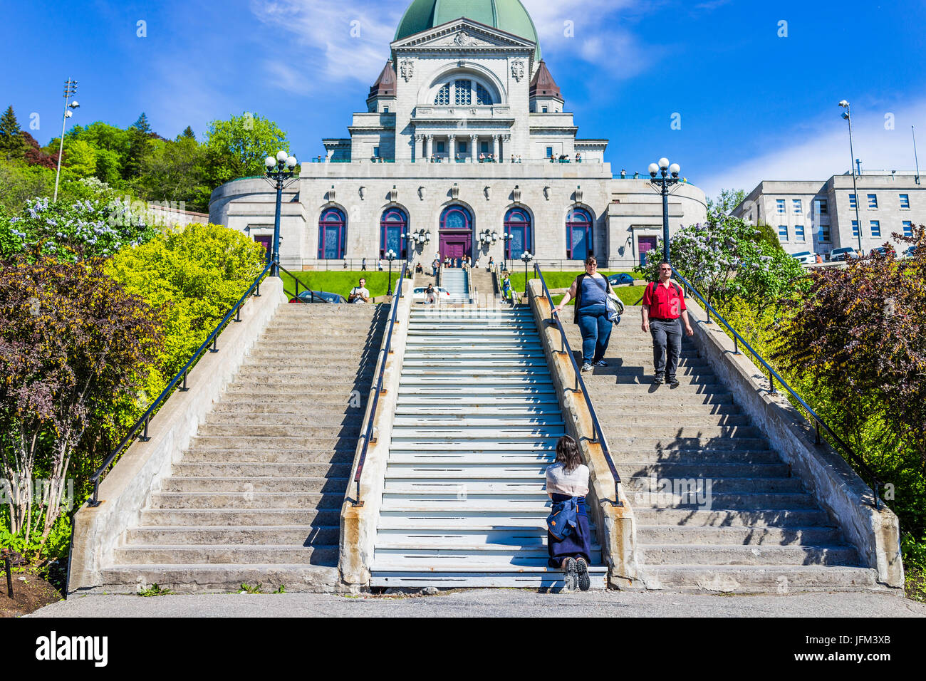 Montreal, Canada - May 28, 2017: St Joseph's Oratory on Mont Royal with woman praying on steps in Quebec region city Stock Photo