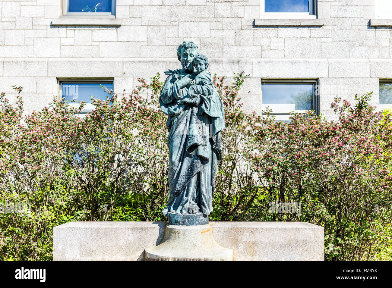 Montreal, Canada - May 28, 2017: St Joseph's Oratory on Mont Royal with statue of the saint holding Jesus Christ in Quebec region city Stock Photo