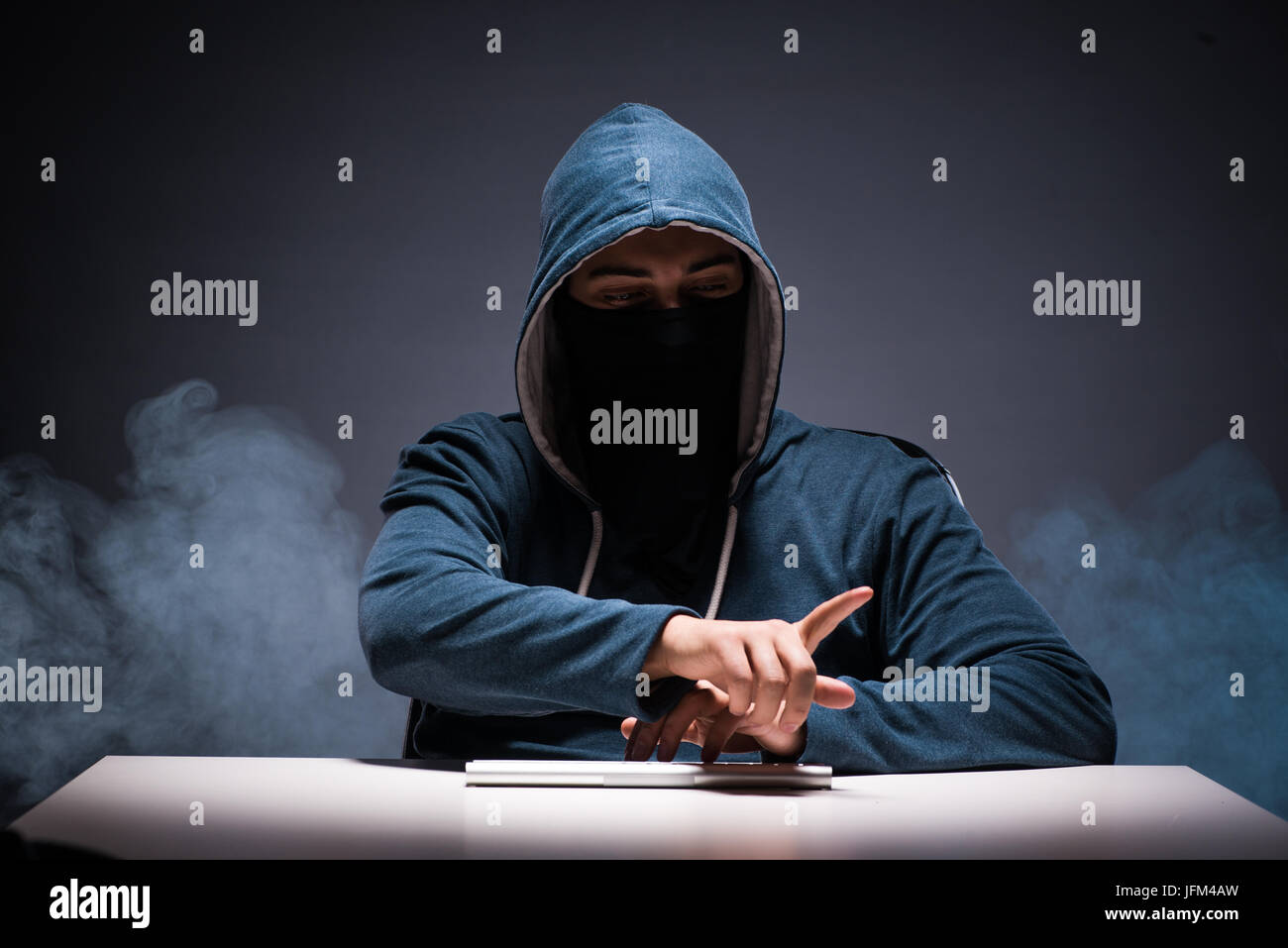 Computer hacker working in dark room Stock Photo - Alamy