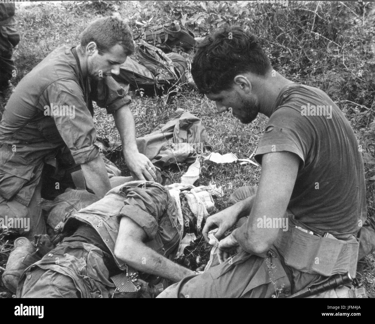 Members of Charlie Company administer emergency first aid to a wounded Marine following the detonation of a booby trap. 2/68 Stock Photo