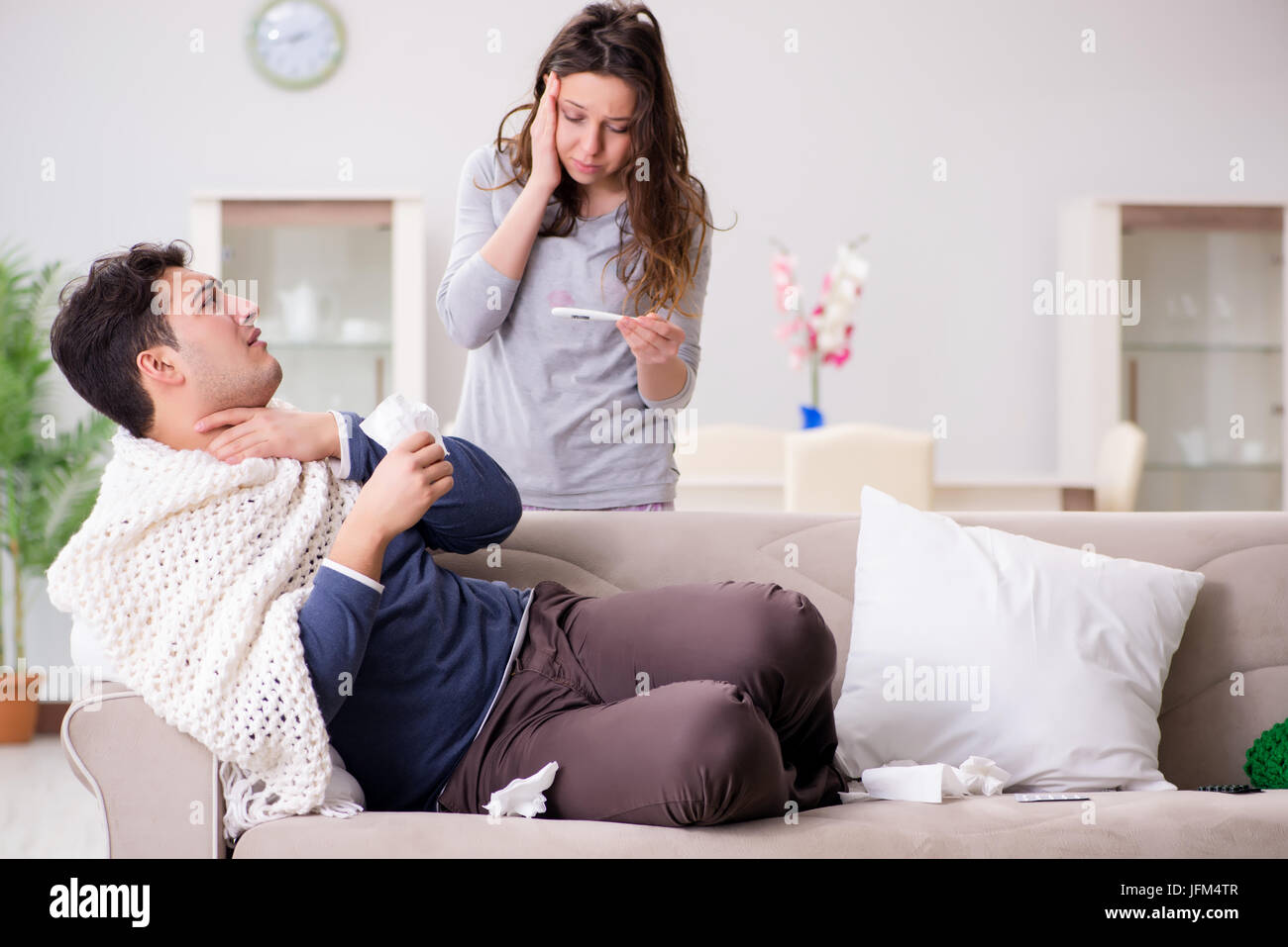 Wife caring for sick husband at home Stock Photo - Alamy