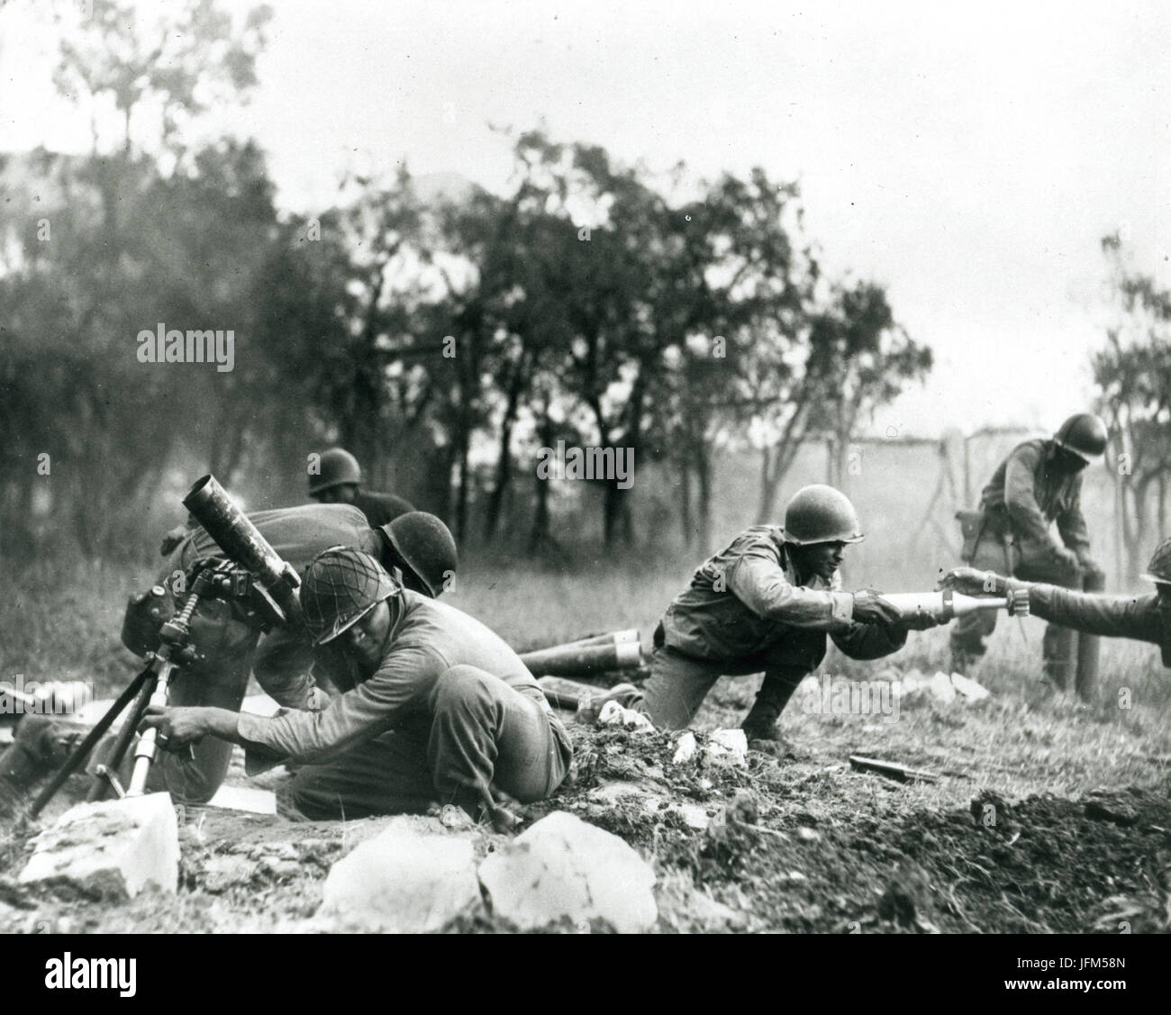 November 1944 - Members of a Negro mortar company of the 92nd Division pass the ammunition and heave it over at the Germans in an almost endless stream near Massa, Italy. This company is credited with liquidating several machine gun nests. Stock Photo