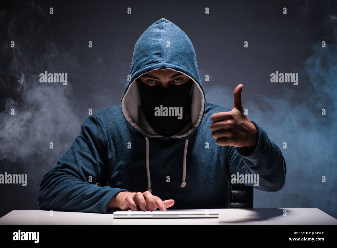 Computer hacker working in dark room Stock Photo - Alamy