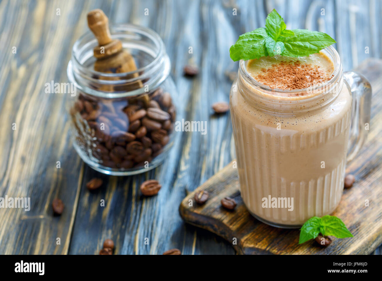 Coffee smoothie with banana and yogurt in a glass jar. Stock Photo