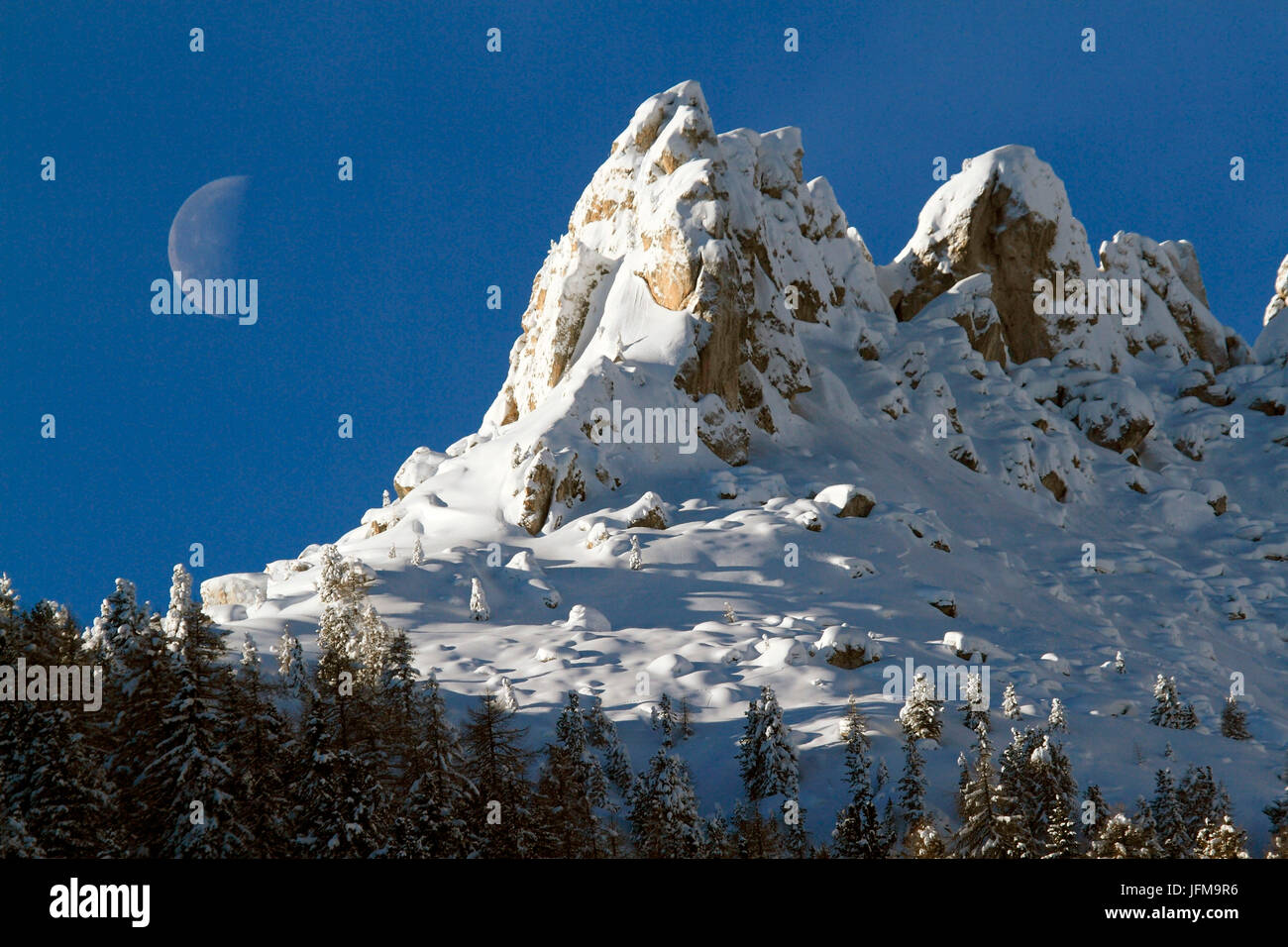Big Moon behind the southern side of Catinaccio group, Dolomites, Gardeccia, Val di Fassa, Trento, Trentino Alto-Adige, Italy Stock Photo