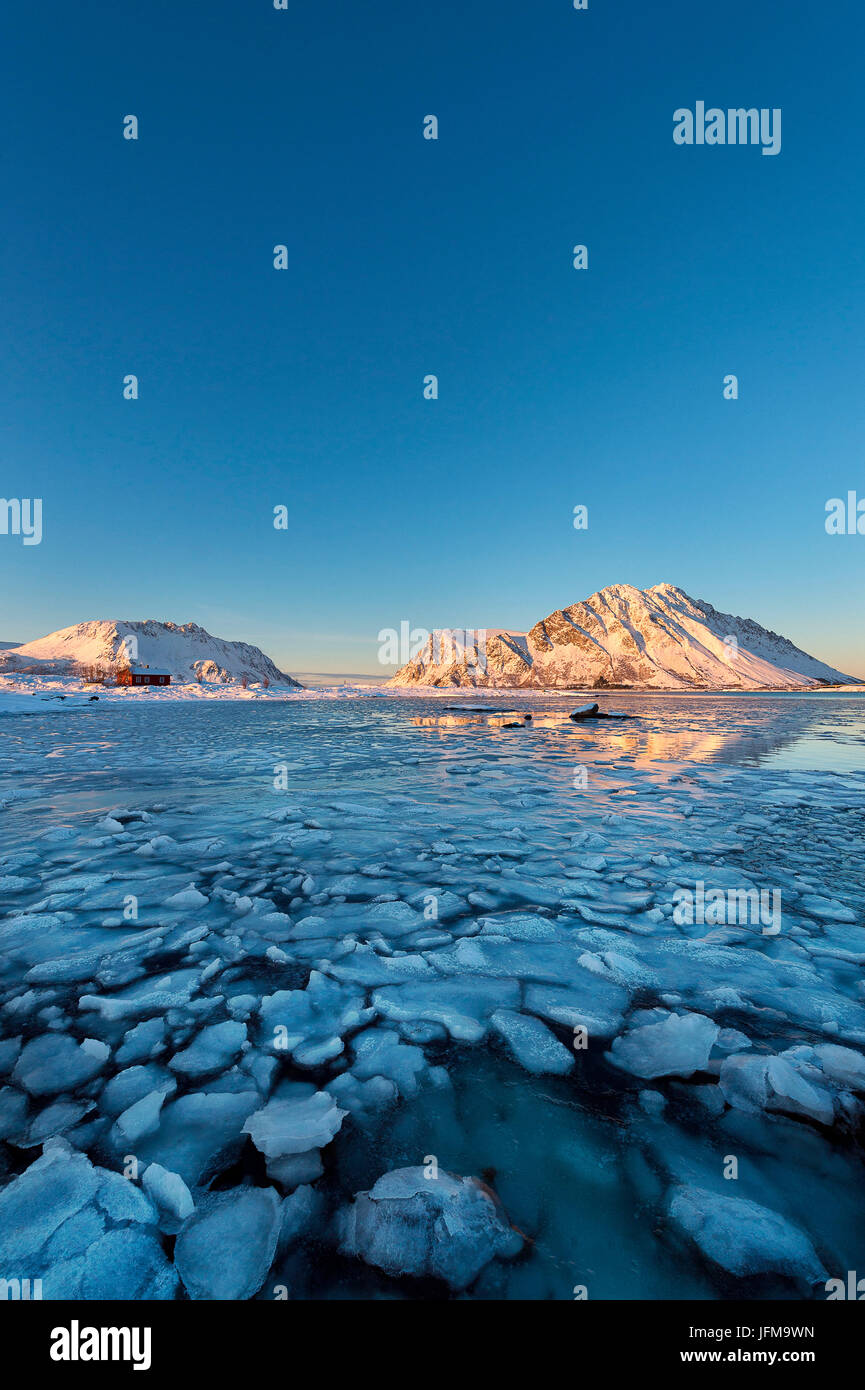 Lofoten Islands, Norway A bay with icy mountains in the background and a rorbu January 2015 Stock Photo