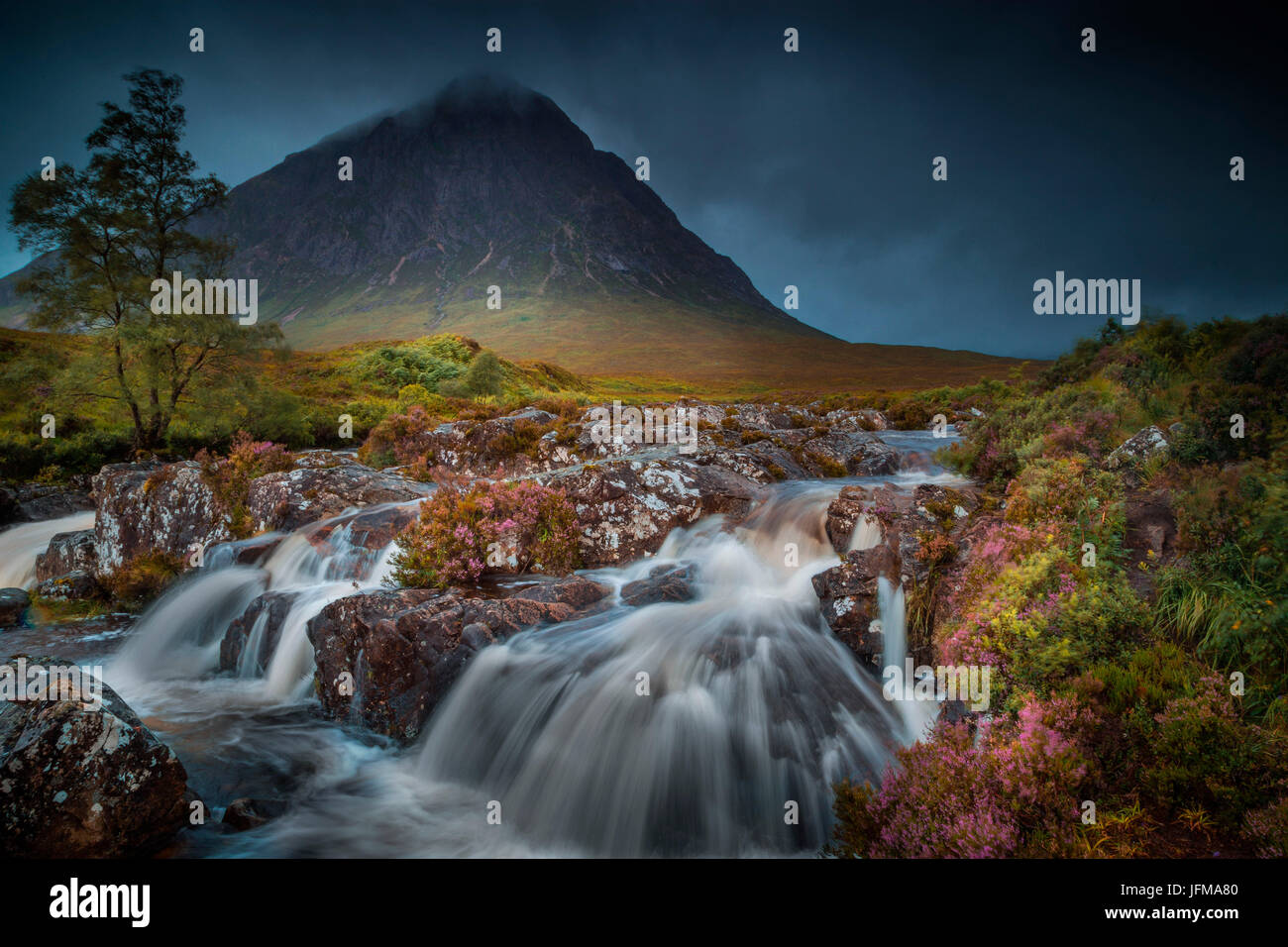 Glen Coe, Scotland, The majestic Buachaille Etive Mor, in Glen Coe, under a storm, with the river falls on the foreground and the mountains on the background, Stock Photo