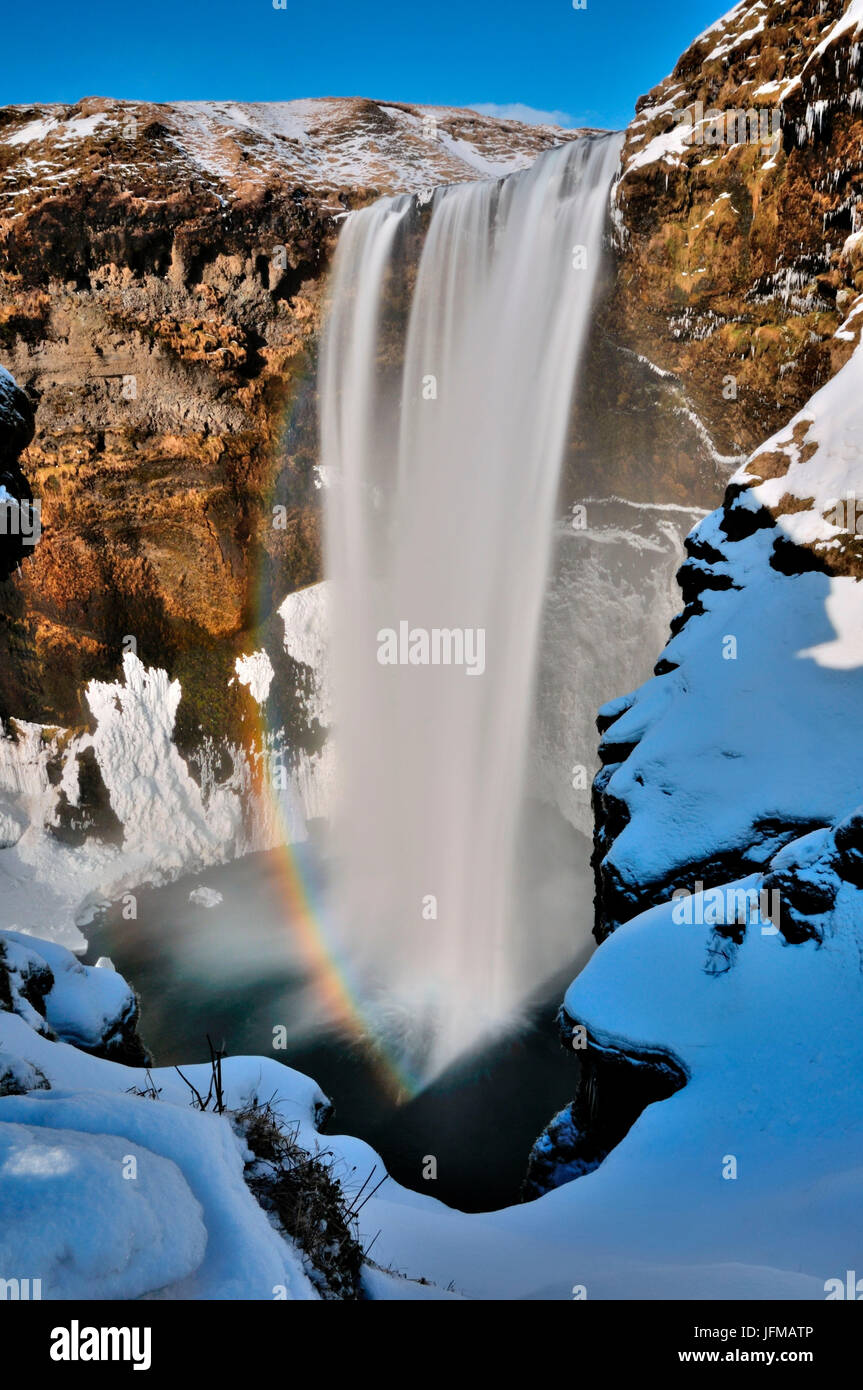 Skógafoss waterfall in a sunny day of winter with rainbow, Iceland Stock Photo