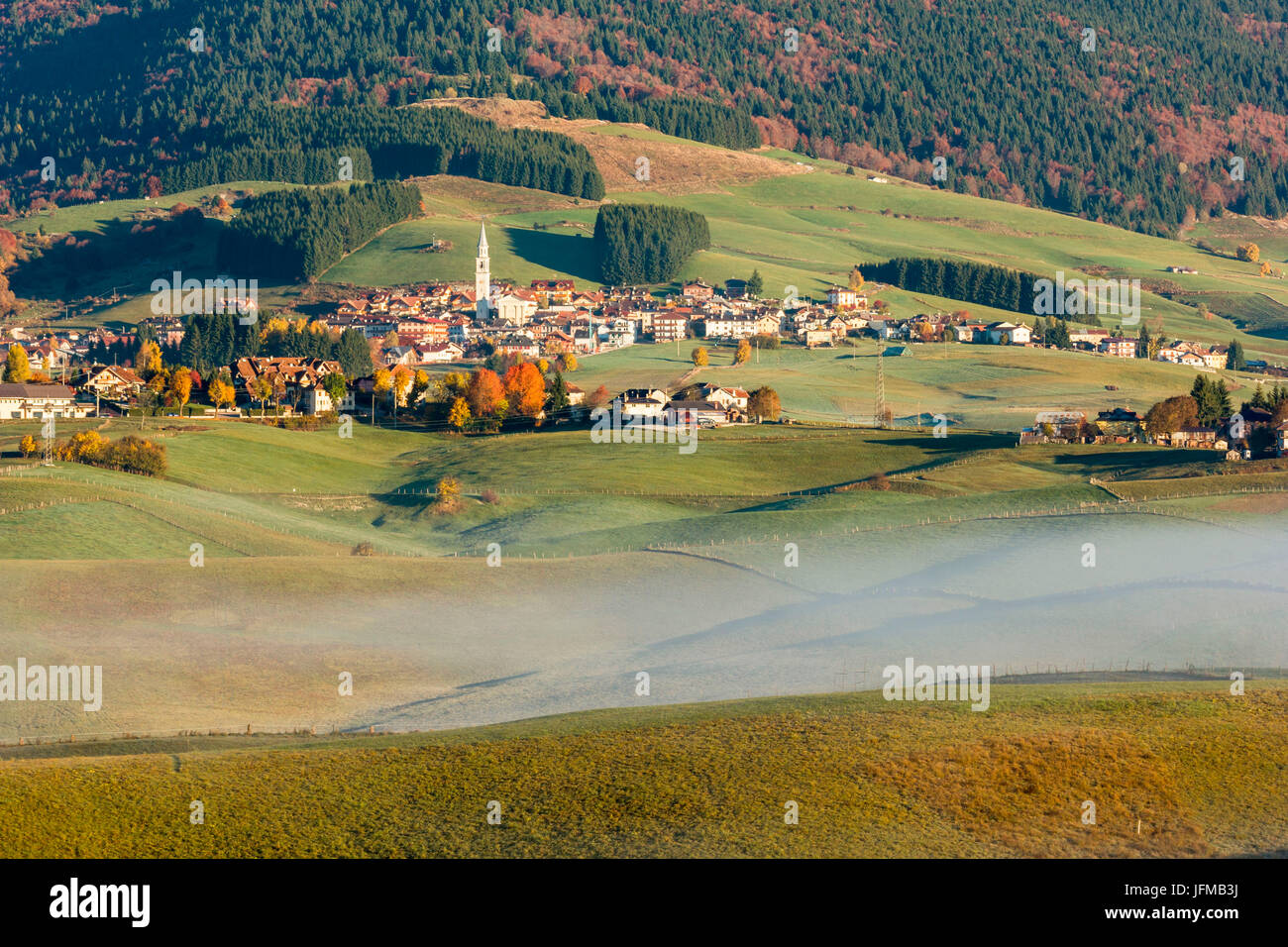 Town, Altopiano of Asiago, Province of Vicenza, Veneto, Italy, Autumn landscape with mist, Stock Photo