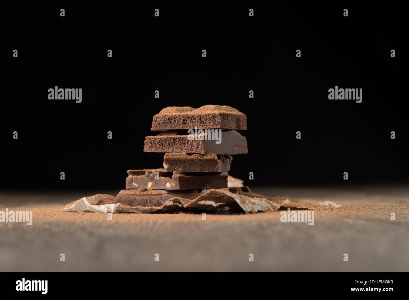 Pyramid of chocolate on table at empty black background Stock Photo - Alamy