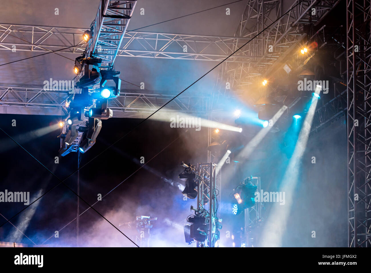concert lighting on stage. lighting equipment with multi-colored beams. Stock Photo