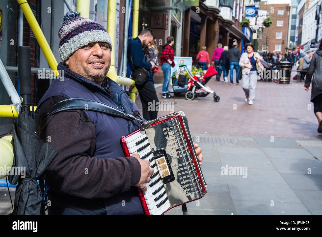 Street performer playing Turkish folk music on an accordion in Shrewsbury Towncentre, UK. Stock Photo