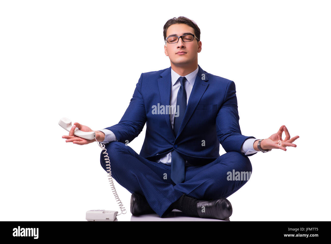 Businessman meditating on the floor isolated on white Stock Photo - Alamy