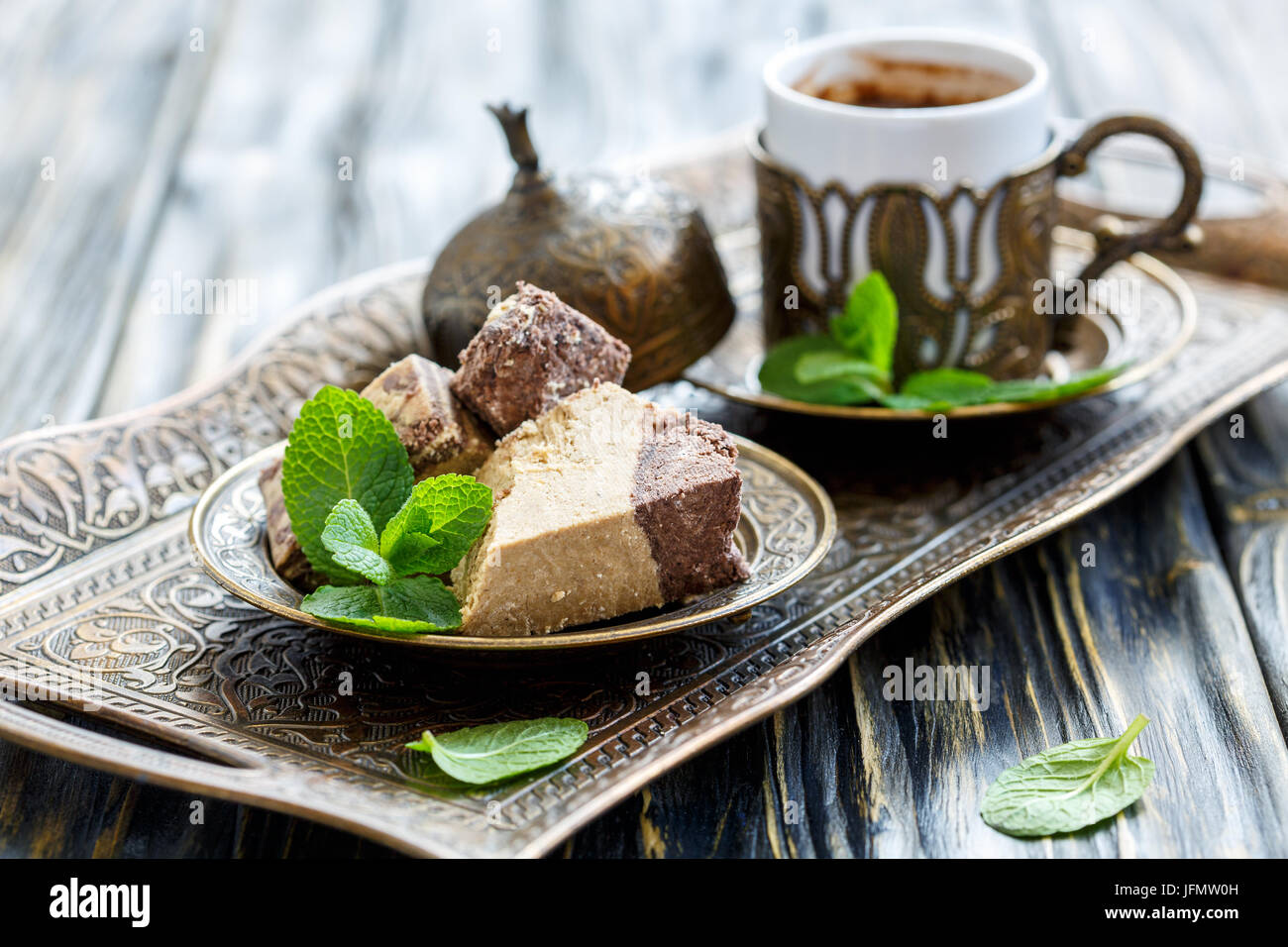 Plate with halva tahini with chocolate and black Turkish coffee Stock
