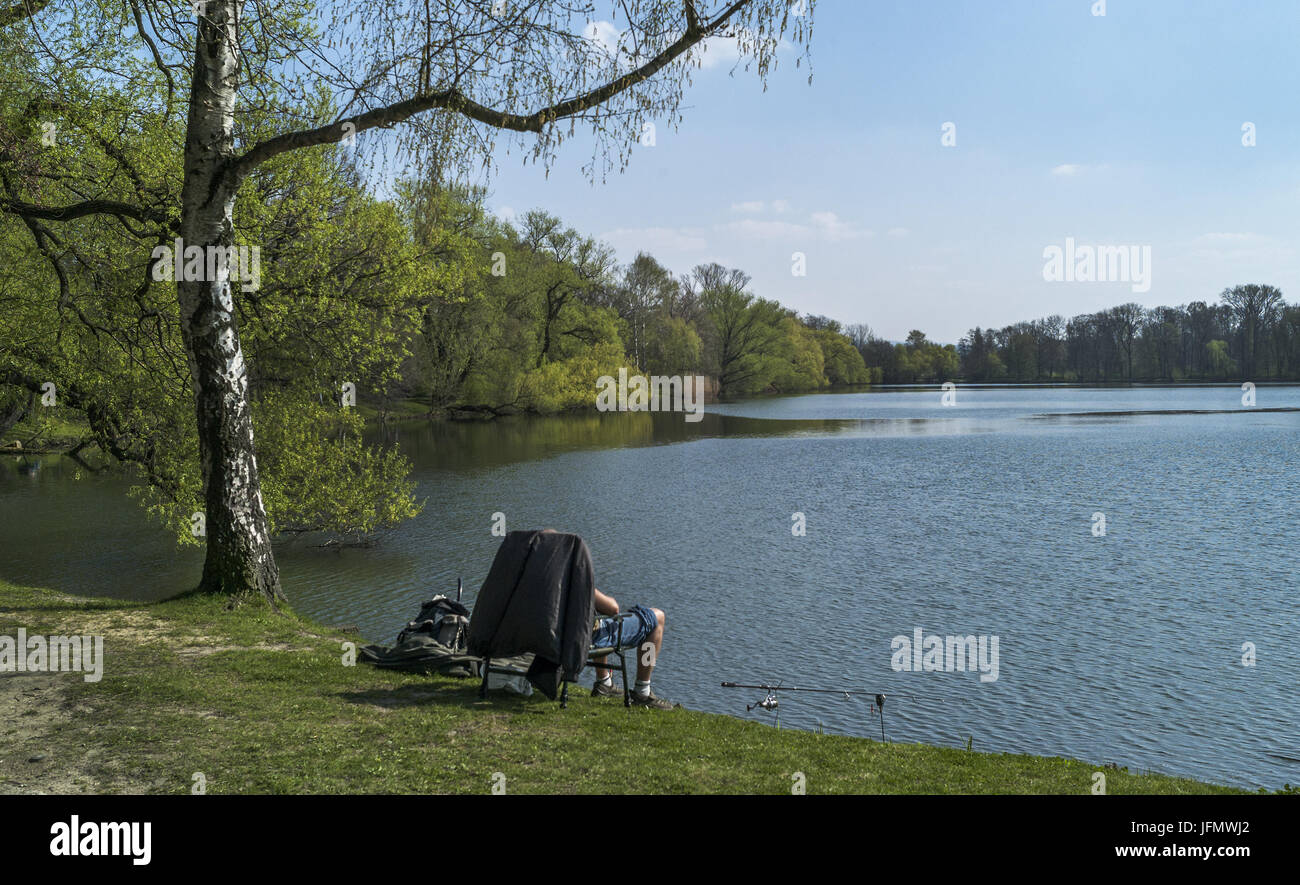 Evening relaxation - angler at the pond Stock Photo