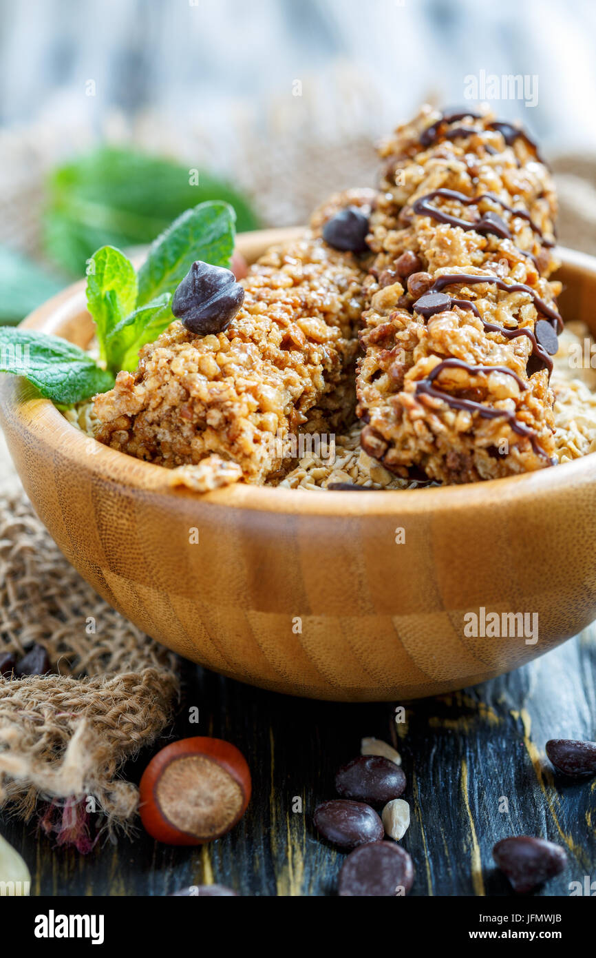 Muesli bars with chocolate and hazelnuts in a wooden bowl. Stock Photo