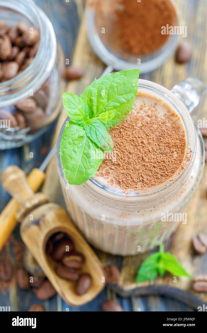 Coffee smoothie and mint leaves in a glass jar. Stock Photo