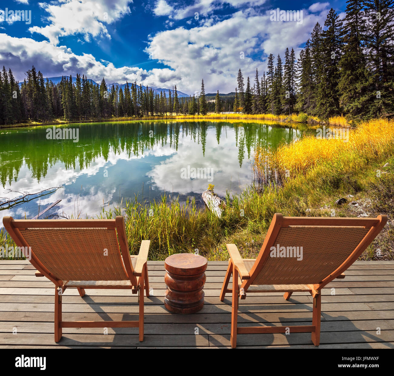 Two deckchairs for tourists on ashore shallow lake Stock Photo - Alamy