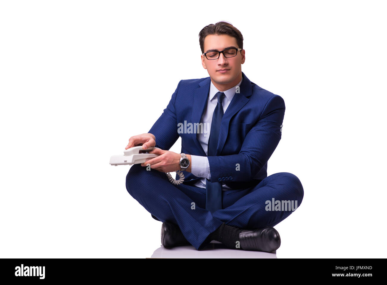 Businessman meditating on the floor isolated on white Stock Photo - Alamy