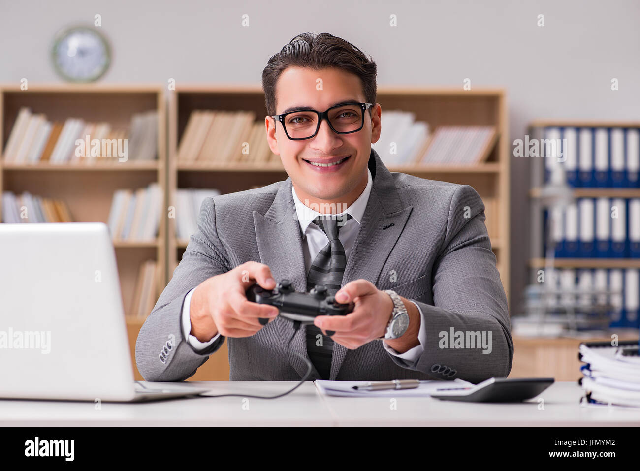 The businessman playing computer games at work office Stock Photo Alamy