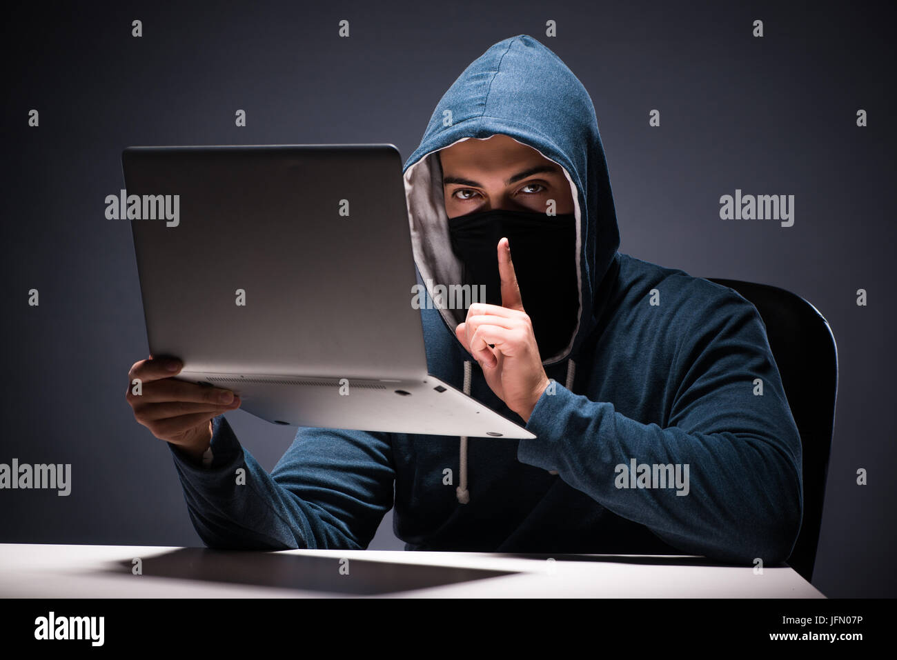 The computer hacker working in dark room Stock Photo - Alamy