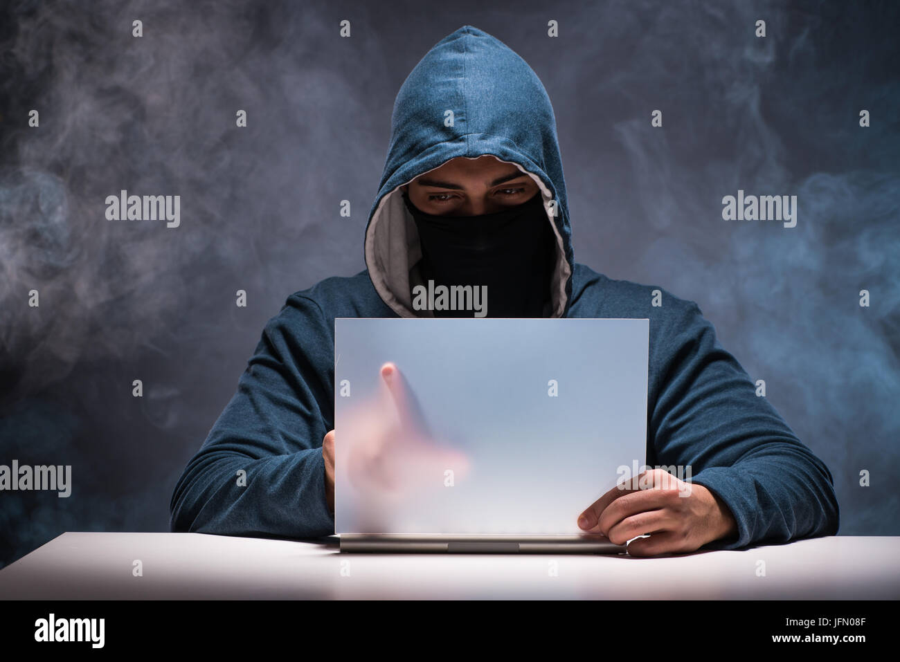The computer hacker working in dark room Stock Photo - Alamy