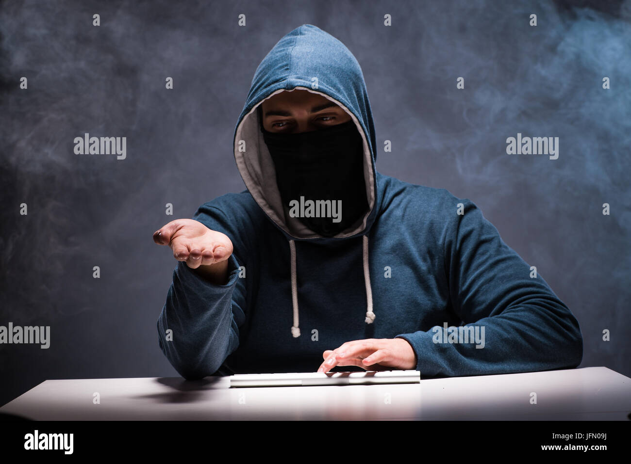 The computer hacker working in dark room Stock Photo - Alamy