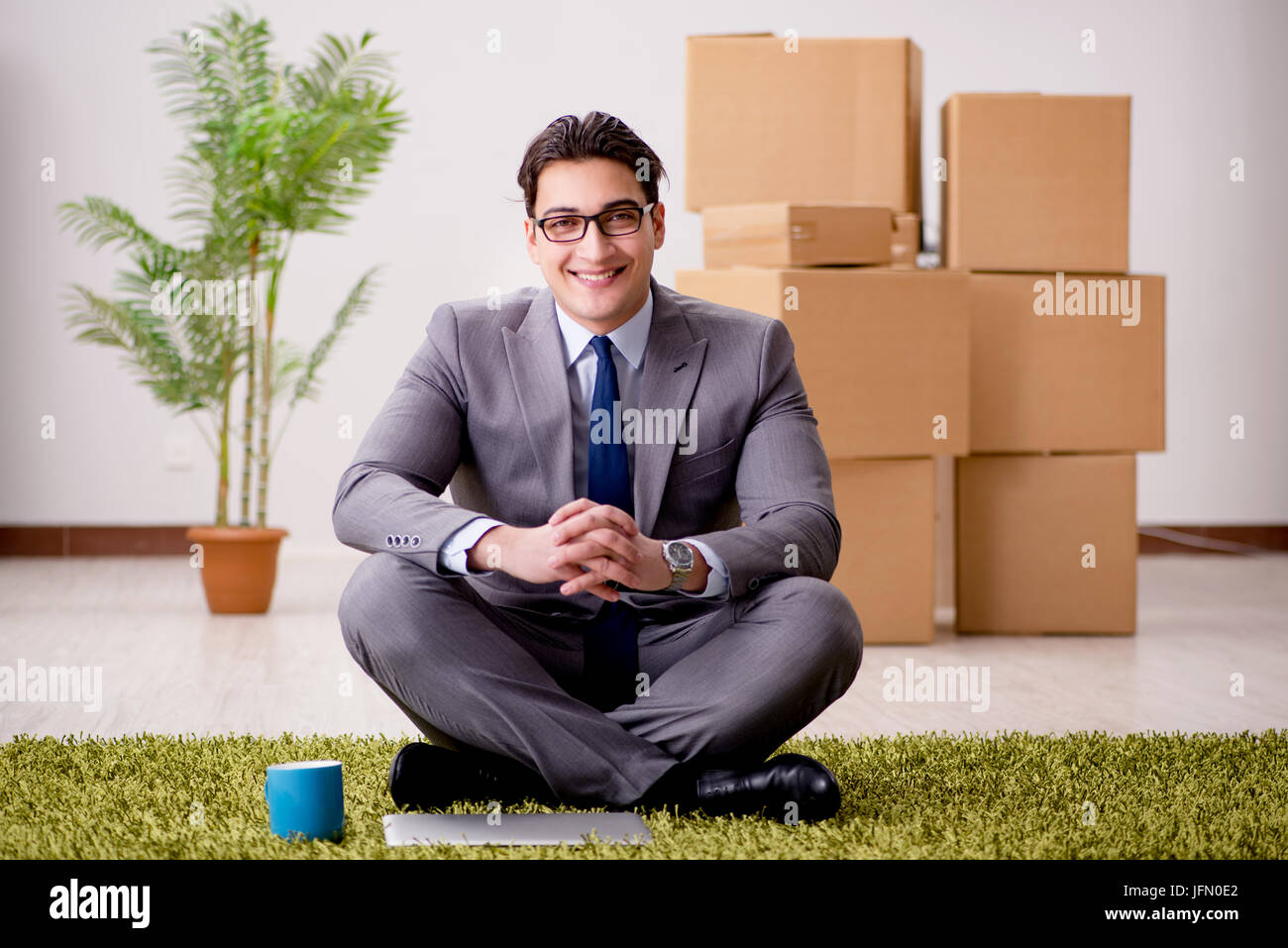 Businessman sitting cross legged on floor hi-res stock photography and ...